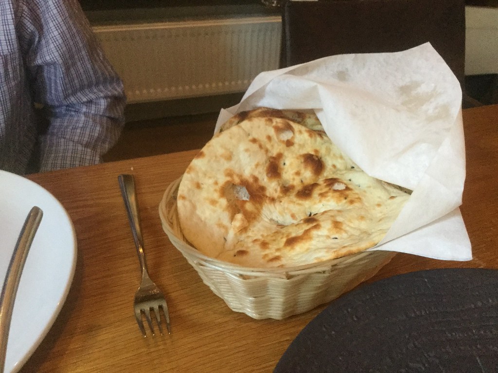 Basket of fresh naan and tandoori breads