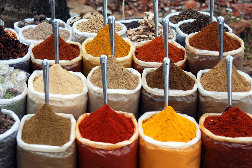 Assorted colourful Indian spices in bowls