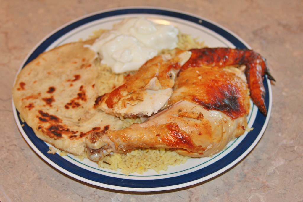 Tandoori chicken pieces charred and garnished on a platter