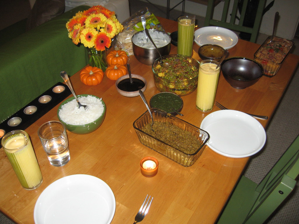 A spread of Indian feast dishes with curries, rice and breads served on a table
